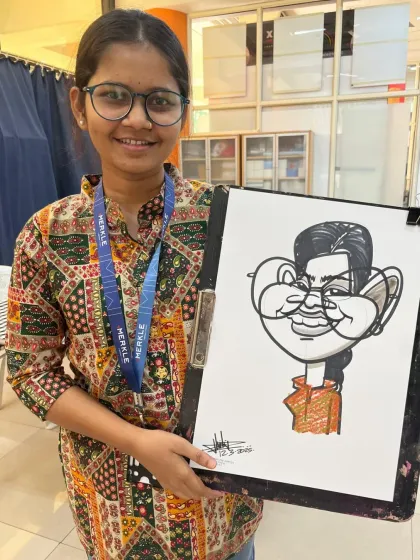A happy employee at the Dentus India Women's Day event. For many, it was their first time getting a caricature, and they loved it.