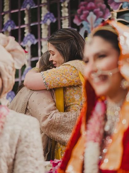 A hug between mothers, caught in the background of the main ceremony. It’s these unscripted, emotional moments between families that I cherish and strive to make space for.