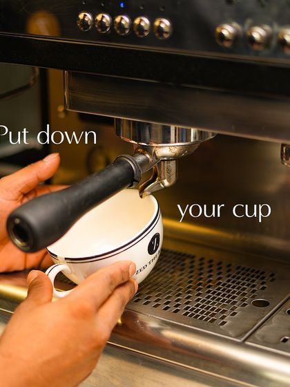 A clean cup is placed under the portafilter, ready to catch the freshly brewed, aromatic espresso shot.