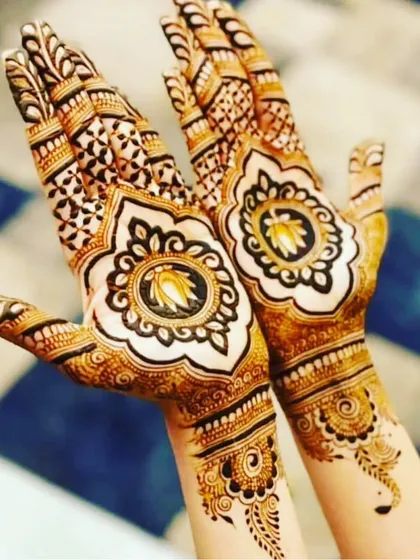 This design showcases a beautiful lotus mandala in the center of the palm. The pattern is symmetrical and creates a stunning focal point on the back of the hands.
