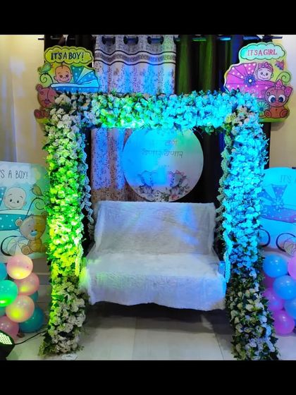 The same home baby shower setup illuminated with green and blue lights, showing how lighting can completely change the mood and ambiance of the decor.