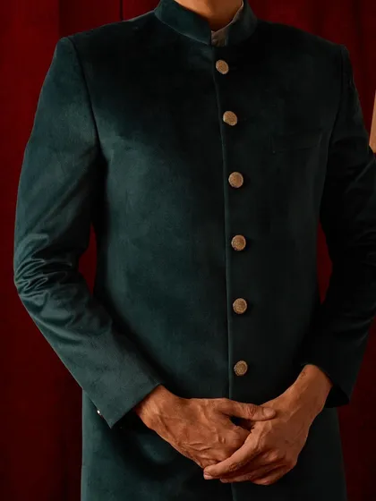 The clean silhouette of our velvet bandhgala. The focus is on the perfect fit and the luxurious fabric, creating a look of understated power.