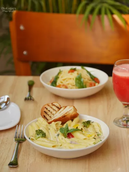 A table for two, featuring our delicious pastas. Whether you prefer a creamy white sauce penne or a classic aglio e olio spaghetti, it's the perfect meal to share with a friend.