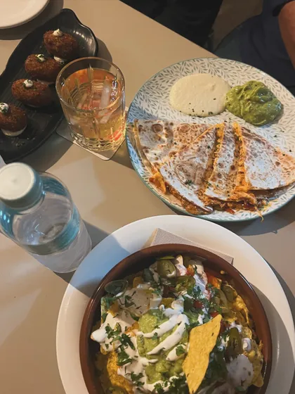 A delicious spread of Mexican food, including loaded nachos and cheesy quesadillas. This is from a local bar in Barcelona that inspired me with its relaxed vibe and flavourful food.
