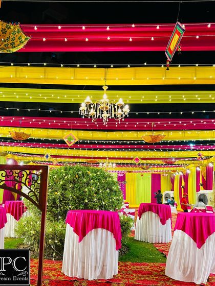 The overall ambiance of a large-scale Mehndi event. I used colorful ceiling drapes with fairy lights and chandeliers to create a festive and grand atmosphere.