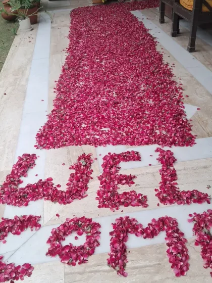 This is a welcome pathway I created using a thick arrangement of fresh red rose petals. The word 'WELCOME' is clearly spelled out at the entrance to greet the person arriving home.
