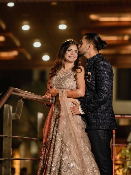 A sweet moment between the engaged couple. Her makeup is soft and radiant, perfect for this romantic shot.