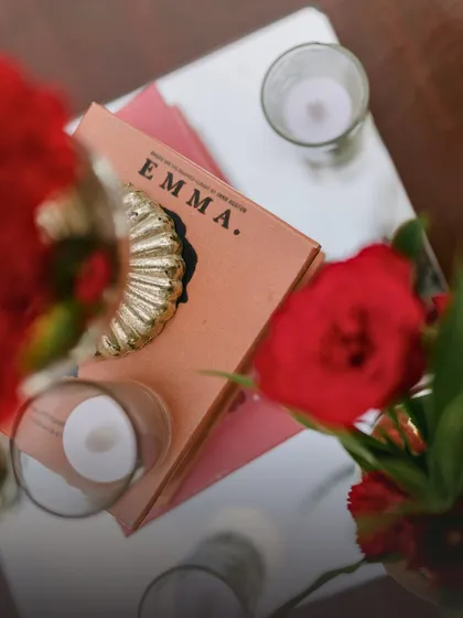 A thoughtful detail from an engagement party decor, where a copy of the classic novel "Emma" is used as a decorative element. This personal touch adds a layer of storytelling to the event.