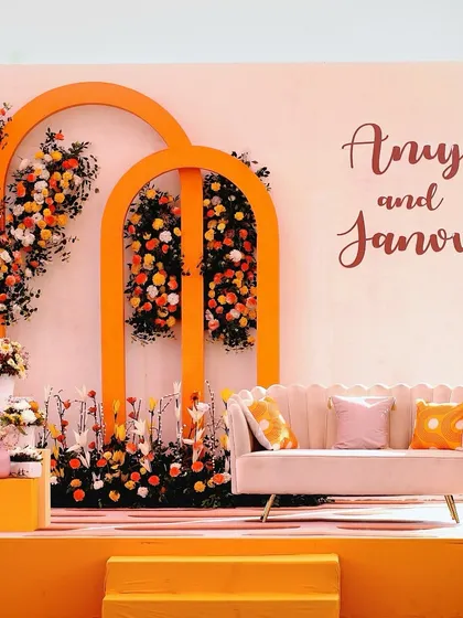 A sun-kissed Haldi ceremony with our 'Love in Mexico' theme. The warm orange tones, cascading marigolds, and clean architectural arches come together to create a vibrant and romantic setting.