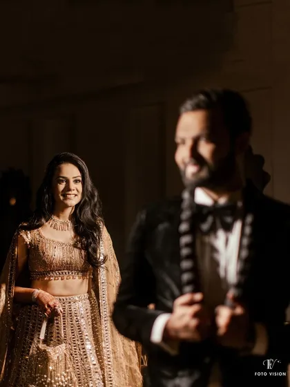 A creative shot focusing on the bride's happy expression as she looks at the groom, who is artfully blurred in the foreground.