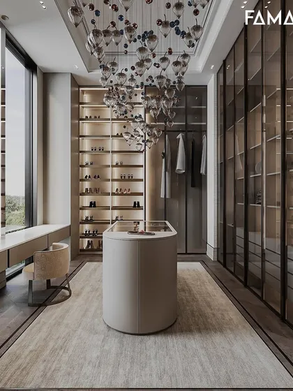 For a truly grand experience, I design dressing rooms with statement pieces. This space includes a stunning chandelier, a curved central island for accessories, and a dedicated vanity area, all framed by floor-to-ceiling shoe shelves and wardrobes.