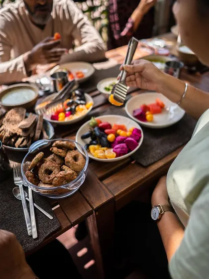 A participant enjoys a plate filled with colorful fruits and healthy, gluten-free baked goods. Our retreats are designed to show you the sheer variety and deliciousness possible within a whole-food, plant-based lifestyle.
