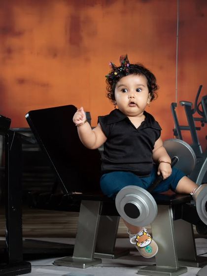This little lady is taking a moment to pose on the weight bench, showing off her cute gym attire.