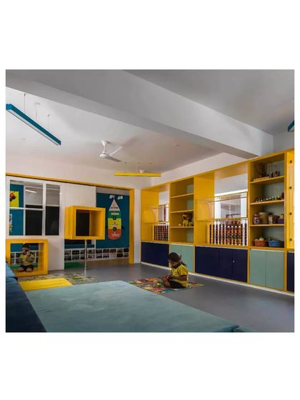 A classroom in the 'Toy Story' preschool, with colorful, child-height shelving and flexible seating. The design is meant to be playful, organized, and stimulating for young learners.