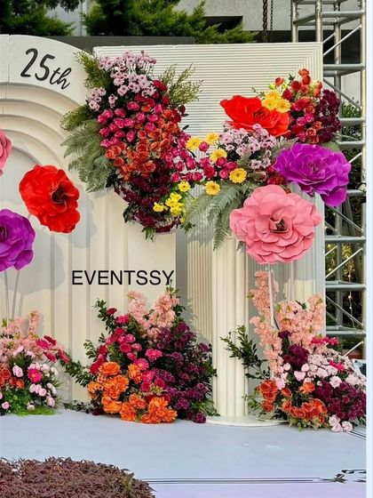 A detail of the floral decor, showing how I combine different types of flowers and handmade paper flowers to create a unique and textured look for this 25th birthday party.