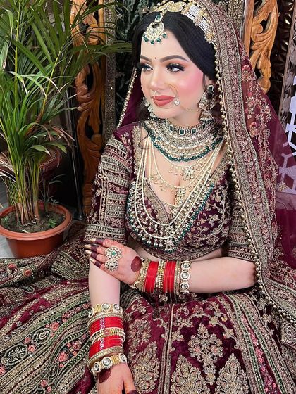 This bride looks like royalty in her deep maroon velvet lehenga. The makeup was designed to be regal and timeless.