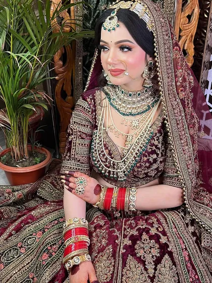 A full-length view of the bride, showing how the makeup, hair, jewelry, and outfit all come together to create a cohesive and breathtaking final look.