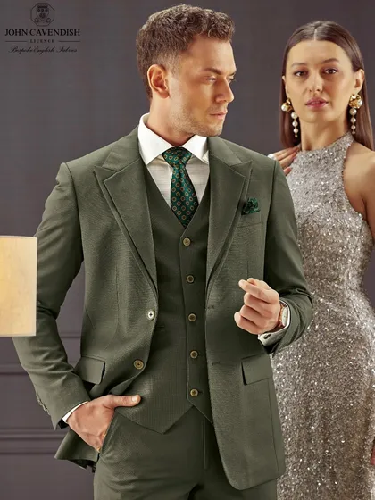 A different pairing for the same brand. The makeup for the female model is a shimmering, silver-toned glam, while the male model's grooming is natural and polished to complement his olive suit.