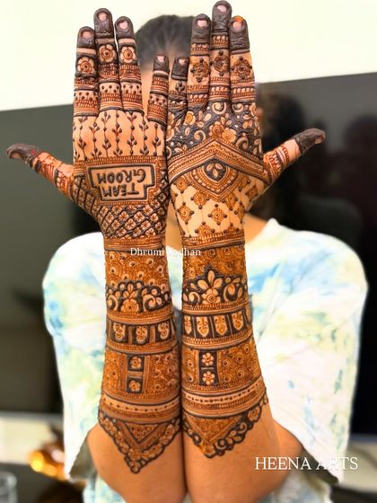 Representing 'Team Groom' with this bold and fun mehendi design, perfect for the groom's side of the wedding party.