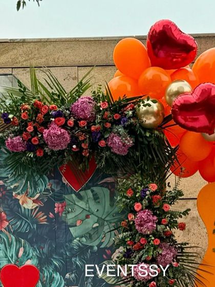 Detail of the floral garland and tropical backdrop from the "Little Cutie" baby shower.