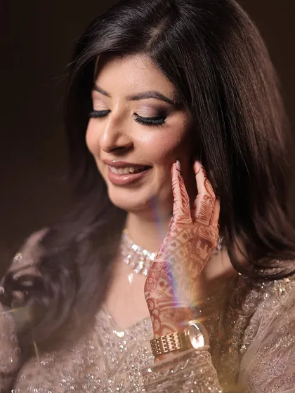 Kanika, smiling and radiant. The makeup is soft and romantic, perfect for celebrating her love story.