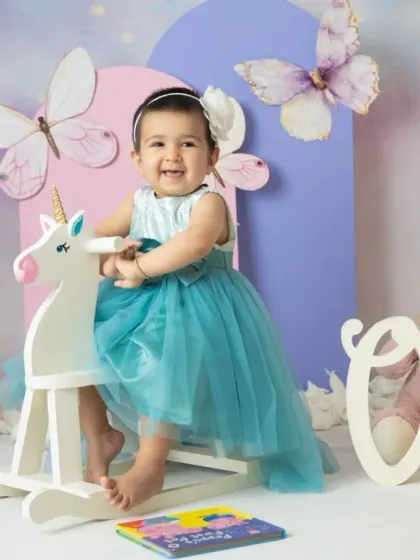 A magical unicorn and butterfly theme for a first birthday. The pastel colors, whimsical props, and dreamy backdrop create a true fairy tale setting.