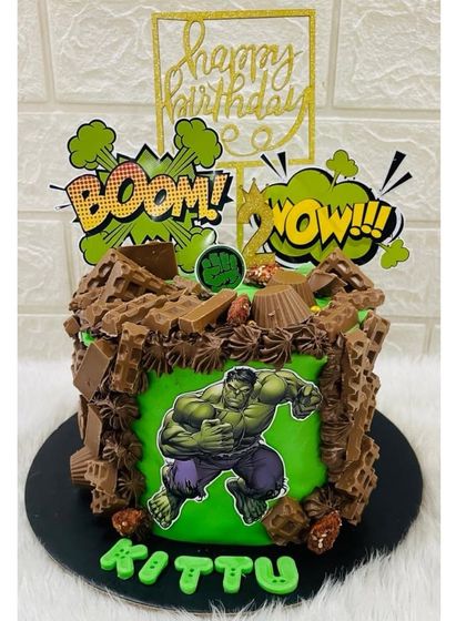 Hulk smash! This powerful Hulk themed cake is covered in chocolate "rubble" and features the green hero bursting out, perfect for a superhero party.
