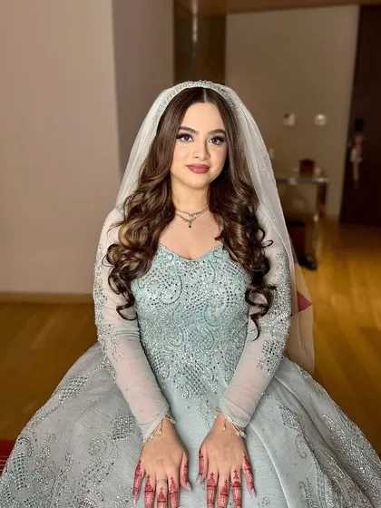 A full portrait of this stunning look. The soft makeup and elegant hairstyle create a timeless and beautiful appearance.