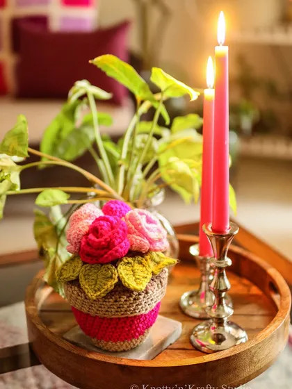 On a grey day, a splash of color is always welcome. My Rosie Posies planter brings a touch of pink to this cozy scene with candles and a wooden tray.