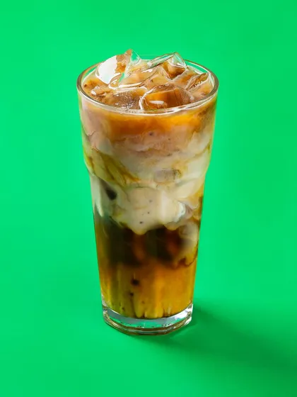 An iced coffee for Bistro by Blinkit, shot against a vibrant green background. This high-contrast style is perfect for digital billboards and online ads.