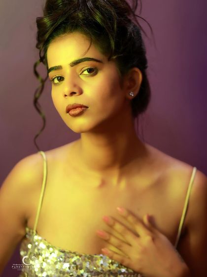 A soft and vulnerable close-up. The hand to her chest adds a layer of emotion and sincerity to the portrait.