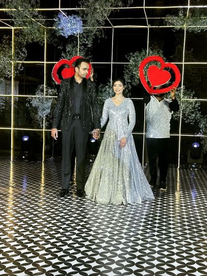 A picture-perfect moment from a fully choreographed entry. My dancers, holding heart props, frame the couple beautifully, creating a fantastic photo opportunity right as they arrive.