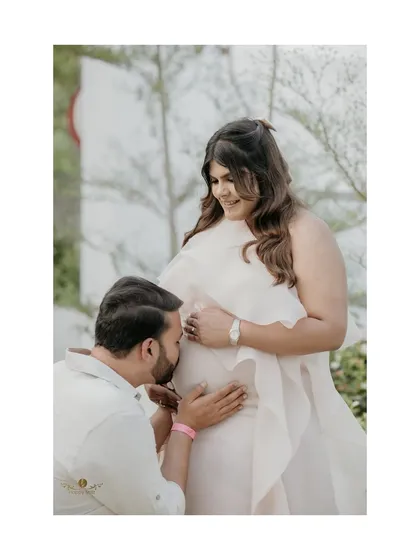 Celebrating the journey to motherhood. This tender moment from a baby shower, with the father-to-be kissing the baby bump, is a perfect example of how we capture the love story of a growing family. It’s a beautiful, emotional maternity portrait.