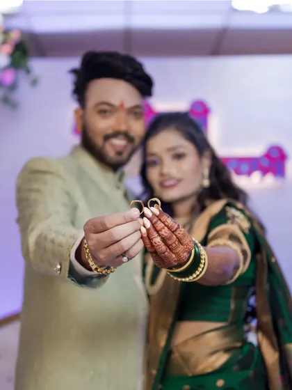 A creative focus shot on the engagement rings held by the couple. This highlights the significance of the rings in a memorable way.