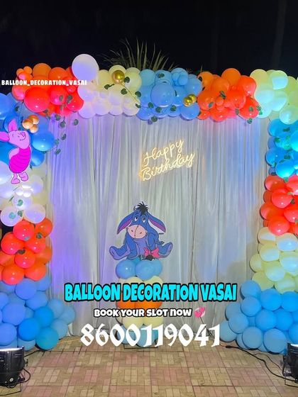 A full Winnie the Pooh and friends theme. This outdoor setup features a colorful balloon arch and cutouts of Pooh, Eeyore, and Piglet.