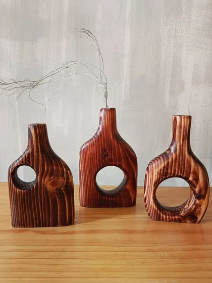 A duplicate of 155, a trio of our hand-carved wooden vases, each with a slightly different shape and grain pattern. Together, they create a beautiful, cohesive decor statement.