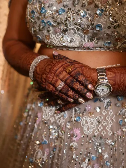 The beautiful dark stain of a full bridal mehndi, perfectly complementing the bride's engagement lehenga.
