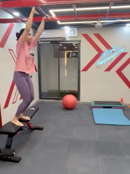 This image captures a dynamic jump onto a bench, part of an advanced phase of rehabilitation. Such exercises are designed to rebuild explosive power and trust in the body's capabilities after an injury.