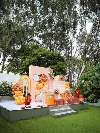 Another view of the "Lion King" themed birthday party stage at The Backyard. The tall trees in the background add to the natural, jungle-like feel of the event.