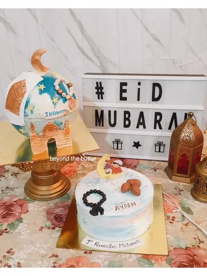 A beautiful Eid Mubarak celebration setup featuring two of my custom cakes. One is a larger piñata cake, and the other is a smaller cake decorated with almonds and a prayer bead design.