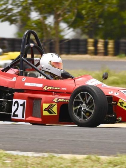 Our driver in the number 21 Formula LGB car, focused and determined during a competitive race.