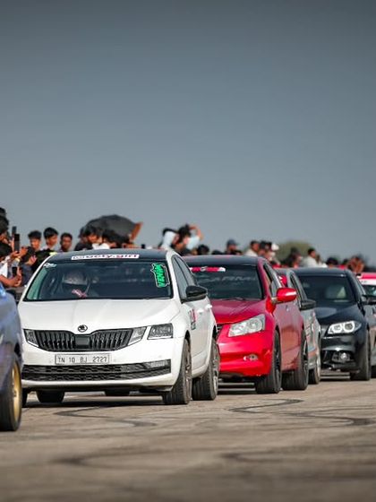 Another view of the impressive car lineup, with a custom blue widebody car at the front. The visual diversity of the machines is a huge part of the spectacle.