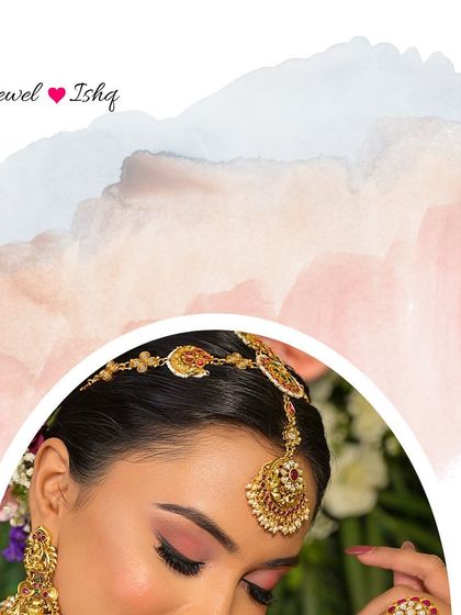 A close-up of a bride's headpiece, showing a beautiful gold-plated Temple Jewellery mathapatti.