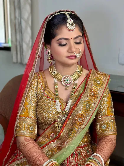 A closer look at this traditional bridal makeup. The eyes are softly defined, the skin is luminous, and the lip color perfectly balances the ornate outfit.
