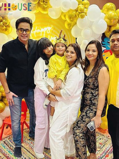 A happy family photo at the Ramayan-themed party, celebrating with friends and loved ones.