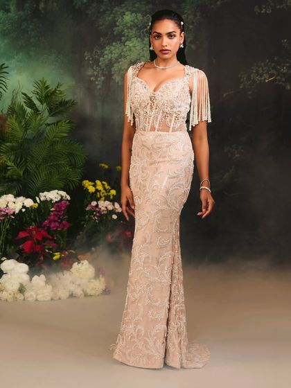 The full silhouette of the Nuray Gown, where the embellished, sheer corset top meets a gracefully embroidered skirt for a look of sophisticated glamour.