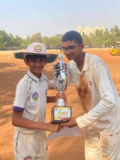 Two of our U-17 players proudly holding the MPL championship trophy on the field. Moments like these build confidence and team spirit.