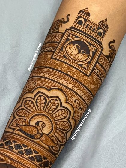 The completed arm design, featuring a beautiful peacock, a pair of swans, and majestic elephants, all tied together with intricate traditional patterns.