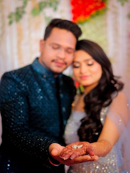 A creative shot focusing on the engagement ring in the bride-to-be's hand.