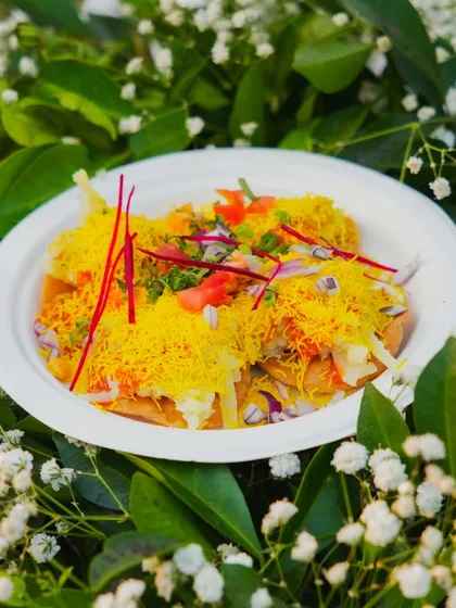 My live chaat counter is always a hit. Here is a plate of freshly made Sev Puri, loaded with crispy sev, tangy chutneys, and fresh toppings for that perfect street-food experience, served hygienically.